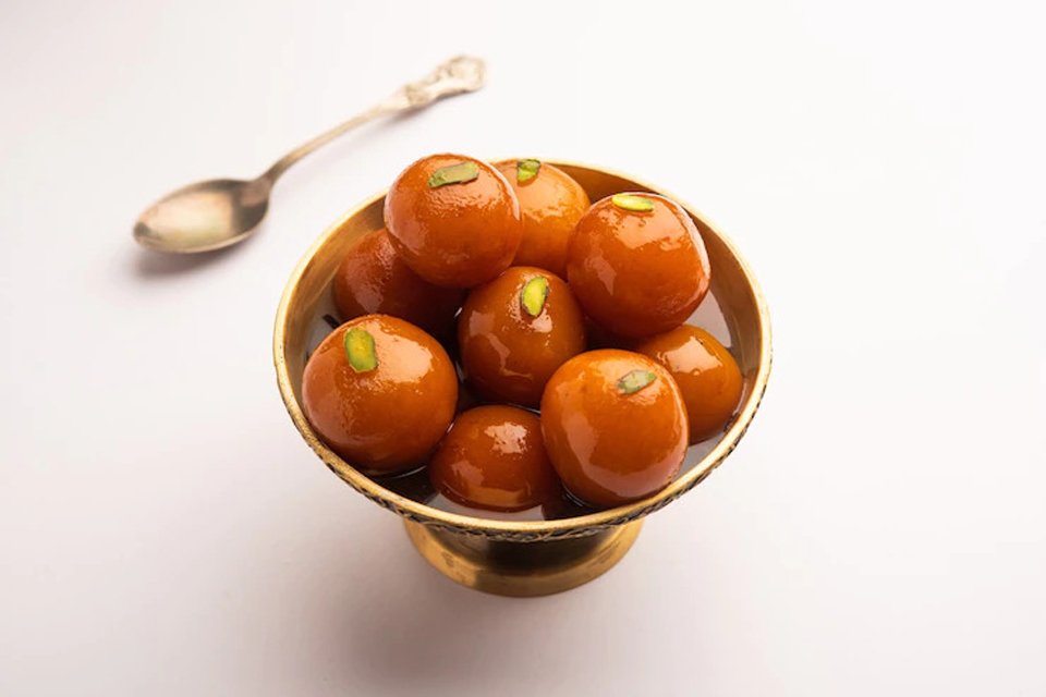 front view of gulab jamun in a bowl.